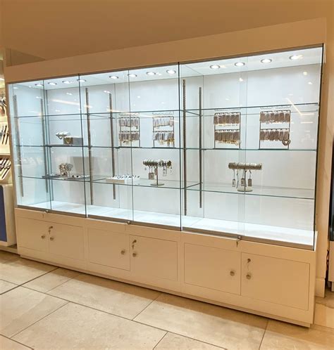 Wide glass display Cabinet with lockable storage and led lights.