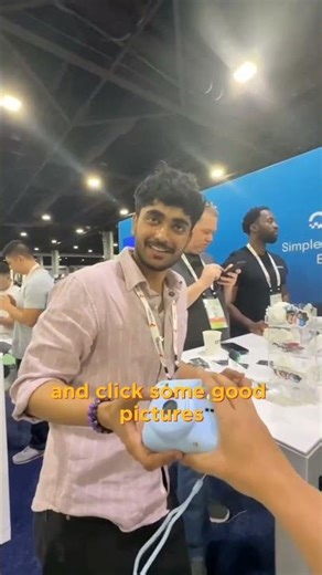 Giving disposable camera to DigitalOcean team at KubeCon NA