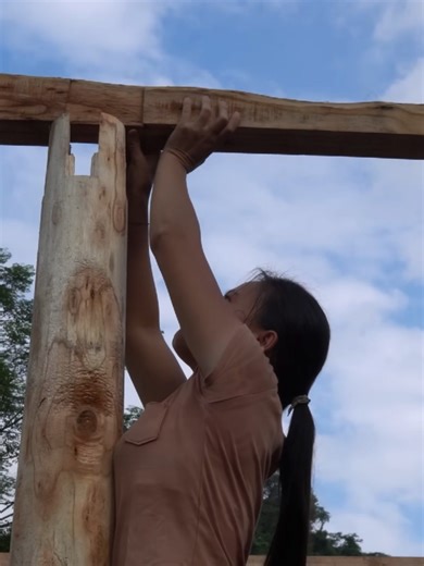 Erecting columns, assembling, striping floors building airy wooden houses for the summer