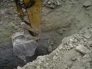 Excavator Ripping Rock