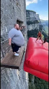 Cliff airbag is wild! 😱🔥 Guy jumps, girl flies! #ScaryRide #TravelWonder