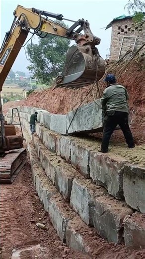 Use rectangular stones to build a retaining wall