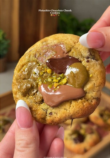 Pistachio-Chocolate Chunk Cookies 🍪(Updated recipe) Ingredients: - 130g unsalted butter, softened - 80g light brown sugar - 80g granulated sugar - 1 large egg 1 large egg yolk - 1 teaspoon vanilla extract - 220g all purpose flour - 1/2 tsp baking powder - A pinch of salt - 70g dark chocolate chunks (60% cocoa content) - 70g milk chocolate chunks - 15g chopped pistachios - Pistachio spread (for the filling) Instructions: 1. Spoon 11 small balls of pistachio spread onto a tray lined with parchmen