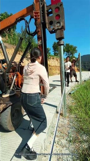 Pile Driver Hammers Steel Tubes into Curved Mountain Road