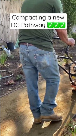 Using a compactor to compact a DG (decomposed granite) pathway