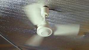 clip-1110571257-installed-ceiling-fan-spins-on-hot-summer