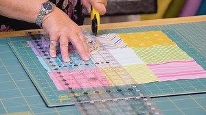 Here's a handy guide to make a stunning Disappearing Nine Patch Quilt! A really fun pattern design that's pleasing on the eye. Katrina's amazing quilt that's hung up behind is two Charms Pack's worth if you're thinking of having a go yourself! | The Sewing Studio UK