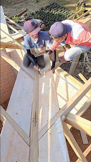 Senior builder teaches how to install gutters properly..