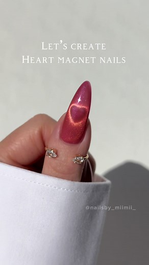 Heart Magnet Nails Tutorial: Step 1: Apply magnet gel. (Don’t cure it yet.) Step 2: Activate the magnet gel first, then bring the paperclip magnet close to your nail where you want a heart shape. Keep it there for a bit (until you see a nice shape of a heart), then quickly move it away. Step 3: Quickly flash cure it! After that, make sure to cure fully. (The shape fades fast, so be speedy!) Step 4: Repeat the process for more hearts, or you can stop after one coat. Step 5: Apply top coat, and yo