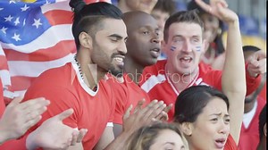 Crowd of spectators watching sports game in stadium cheering on their team Stock Video