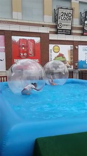 Woman Floats Inside Inflatable Ball in Pool