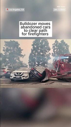 Bulldozer moves abandoned cars to clear path for firefighters