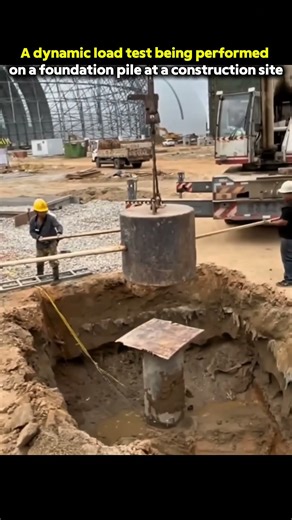 A dynamic load test being performed on a foundation pile at a construction site