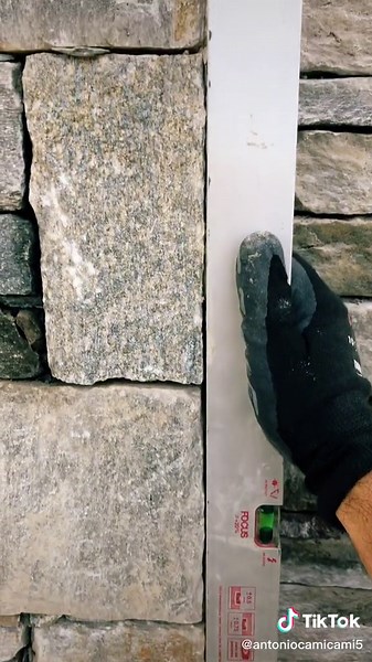 Measuring Stone Wall Alignment with a Level Tool