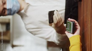 Vertical video of showing QR code, covid vaccination passport control close-up. Scanning coronavirus electronic medical certificate on smartphone in cafe or restaurant, green zone.