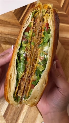 Sheila Williams on Instagram: "ALWAYS craving a crunchwrap & love making them at home👏🏼 Perfect for an easy weeknight dinner or late night snack! •XL burrito-size flour tortilla •taco meat •nacho cheese •shredded cheese •tostada shell •guacamole •sour cream •pico de gallo •chipotle crema •shredded lettuce •small tortilla Instructions: In the center of tortilla, layer: nacho cheese, taco meat, shredded cheese, tostada shell, guacamole, sour cream, pico de gallo, lettuce & small tortilla Fold th