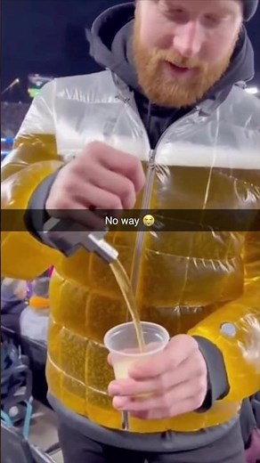 He Brought a Beer Puffer Jacket to the Game! 😂🍺