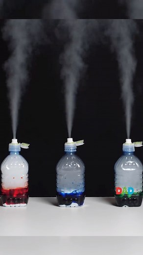 This simple and fascinating dry ice experiment uses only a few items but creates a magnificent reaction. Watch how the ice turns into a gas and produces a smoky or steamy effect. It may remind children of an erupting volcano or even a steam train. Even though it produces a wonderful gassy reaction, it is not hot like you may think it would be. Perfect for the children to get involved in! ⭕ Materials: - Water bottle (with a sports cap) - Dry ice - Gloves - A cup of water - Food colouring - Funnel