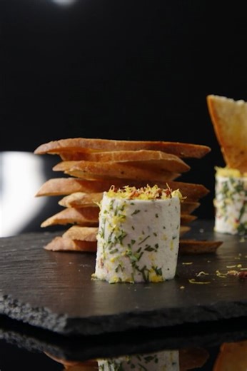 Homemade goat cheese log with tarragon and pink peppercorns