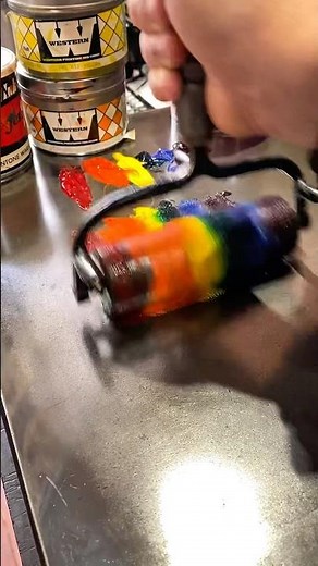 Rolling out 6 colors of ink with a brayer on an ink stone for letterpress printing.