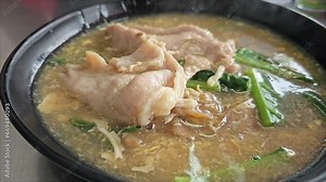 A clip of large noodles topped with pork. You can see the smoke and heat and feel the aroma. Stock Video