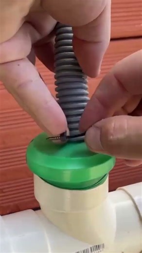 Connect the grey elastic spring hose to the T-connection hole of the white PVC pipe.
