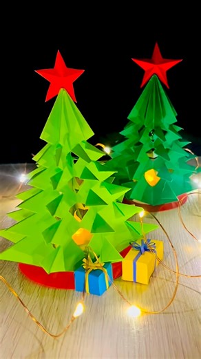 CraftISH corner on Instagram: "DIY table top Christmas tree 🎄 This Christmas tree is all about clean folds, simple cuts, and a classic Christmas look. Simple paper turns into a beautiful decor piece for shelves, tables, or cozy corners, with a small LED light tucked underneath to add a soft glow without stealing the spotlight. Easy to make, fun to display, and completely handmade. Save it for later and tell me where you would place this paper tree ✨ #christmaspapercraft #diychristmasdecor #FBDe