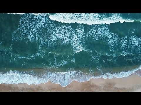 Aerial view of sand beach. Top view sea waves. Drone footage