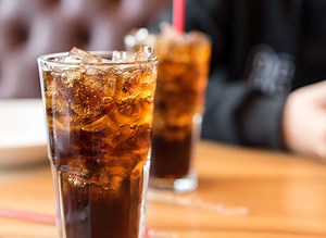 Warning Signs You're Drinking Too Much Soda, According to the Mayo Clinic