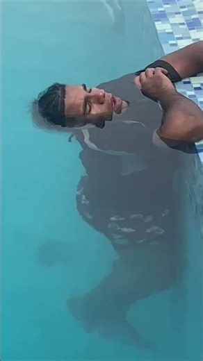 Man Sleeps While Holding to Infinity Pool Edge