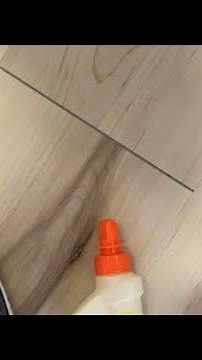 How to fix a gap in vinyl plank flooring using glue and a shoe