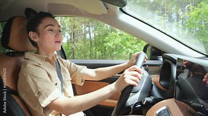 Black-haired businesswoman driver singing favourite song in automobile with excited expression on face. Lady enjoys listening to music during ride, close-up Stock Video
