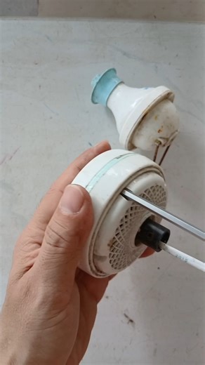 disassemble the broken mini ceiling fan in the pile of toys and old mini fans