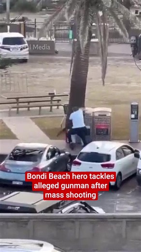 This is the moment a bystander tackled an alleged gunman to the ground during the Bondi Beach mass shooting. Footage appears to show a man tackling one of the gunmen before taking his gun and pointing it at him, forcing the alleged attacker to retreat. New South Wales Police have confirmed that 10 people have died in the shooting, including one gunman. The other gunman is in police custody and injured. A further 11 people have been injured in the shooting, two of whom are police officers, accord