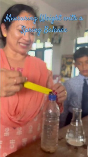 Using a water-filled bottle to check weight by spring extension.