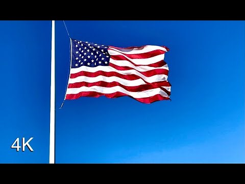 Large American Flag Waving in the Wind Sound Effect and Stock Video | Solid Blue Sky Background | 4K